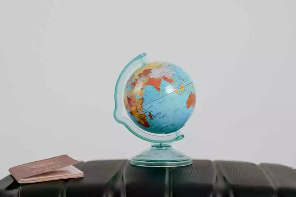 Easy Schengen Visa Application: UAE Residents 5 A globe and a passport on table