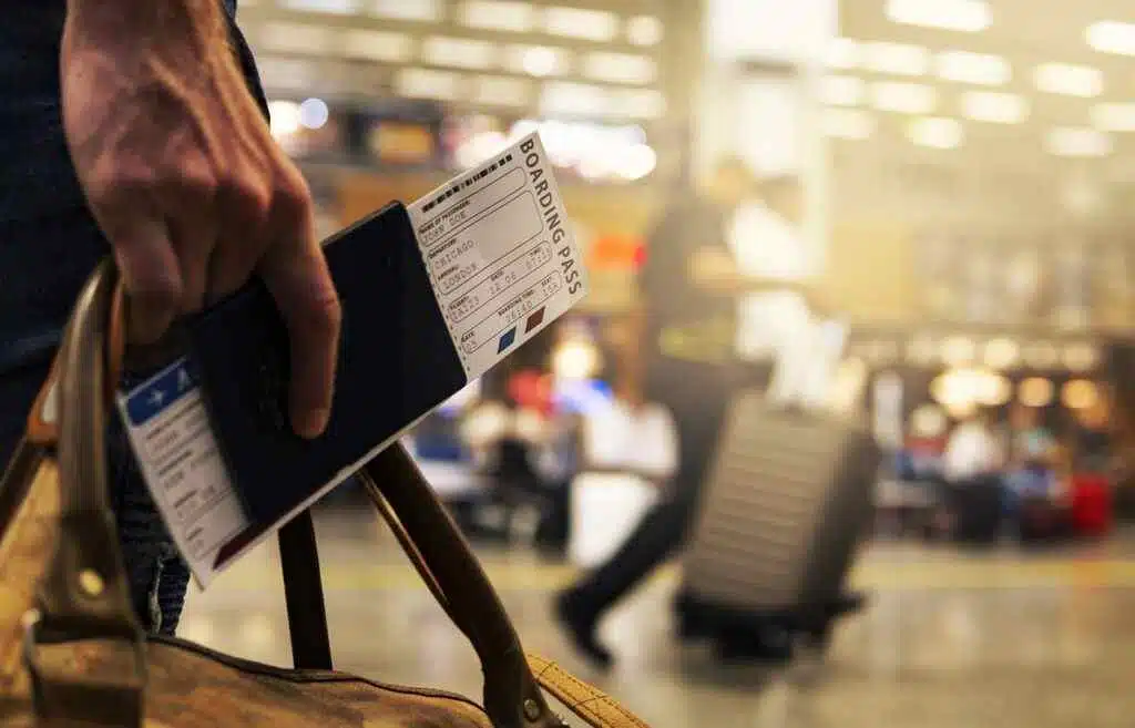 UAE Resident: Explore 100+ Visa-Free Destinations in 2025 3 A man holding his passport and bag on an airport