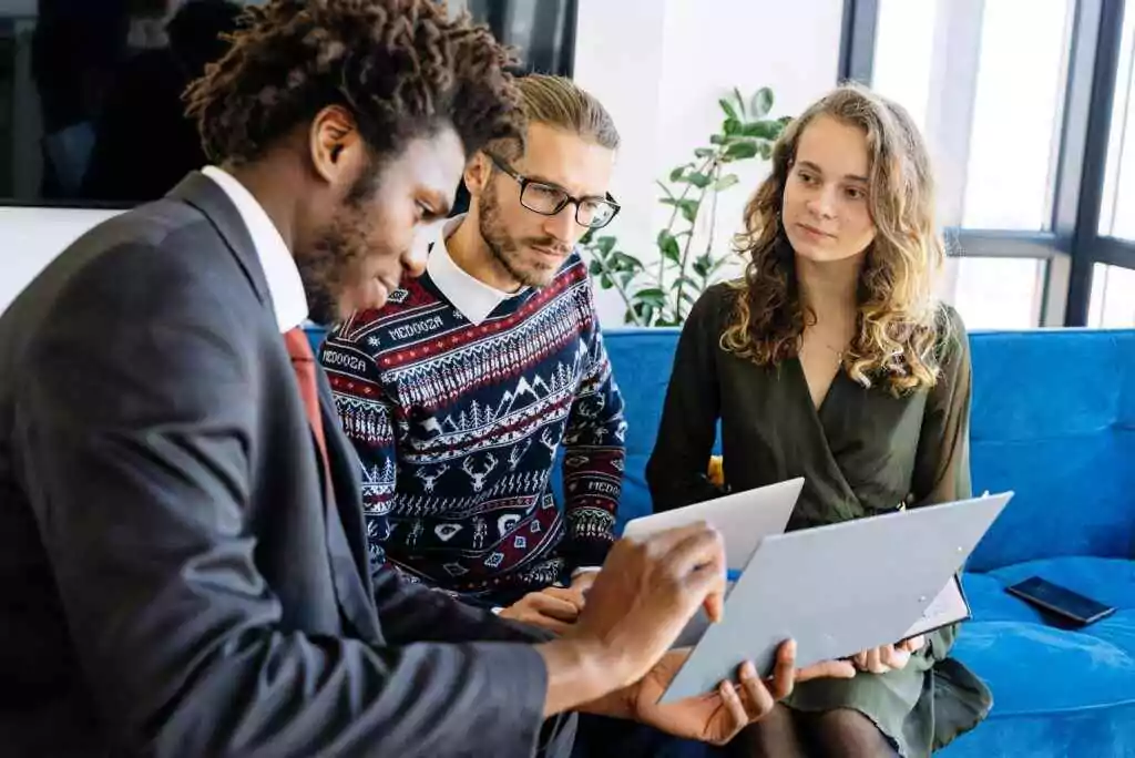 Japan Visa For UAE Residents: Unlock Your Dream Trip Now! 10 A diverse group of young professionals engaged in a business meeting inside a modern office.