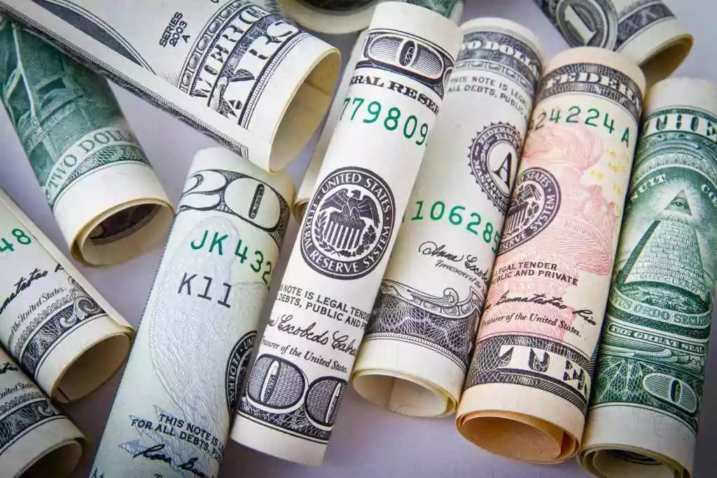 Pay Etihad Water & Electricity Bills: 4 Hidden Methods 16 Close-up of rolled US dollar bills symbolizing wealth, financial success, and currency.