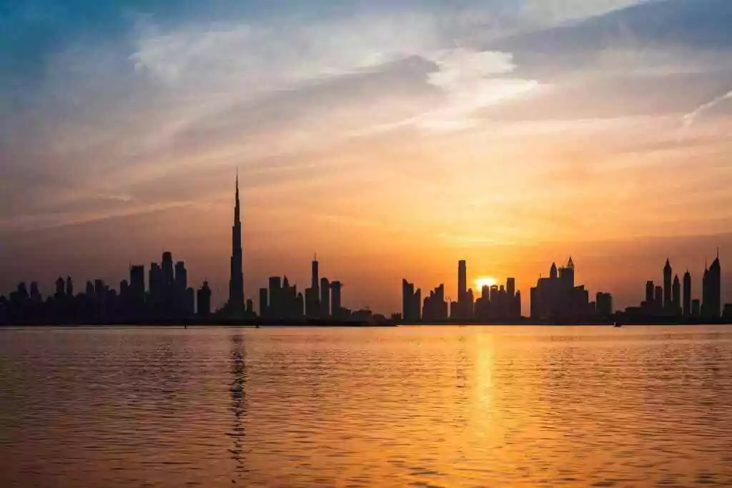 Dubai Creek FAST: Metro Hack in Minutes (Skip Taxis!) 6 Enchanting view of Dubai's skyscrapers at sunset with the iconic Burj Khalifa outlined against the vivid sky.