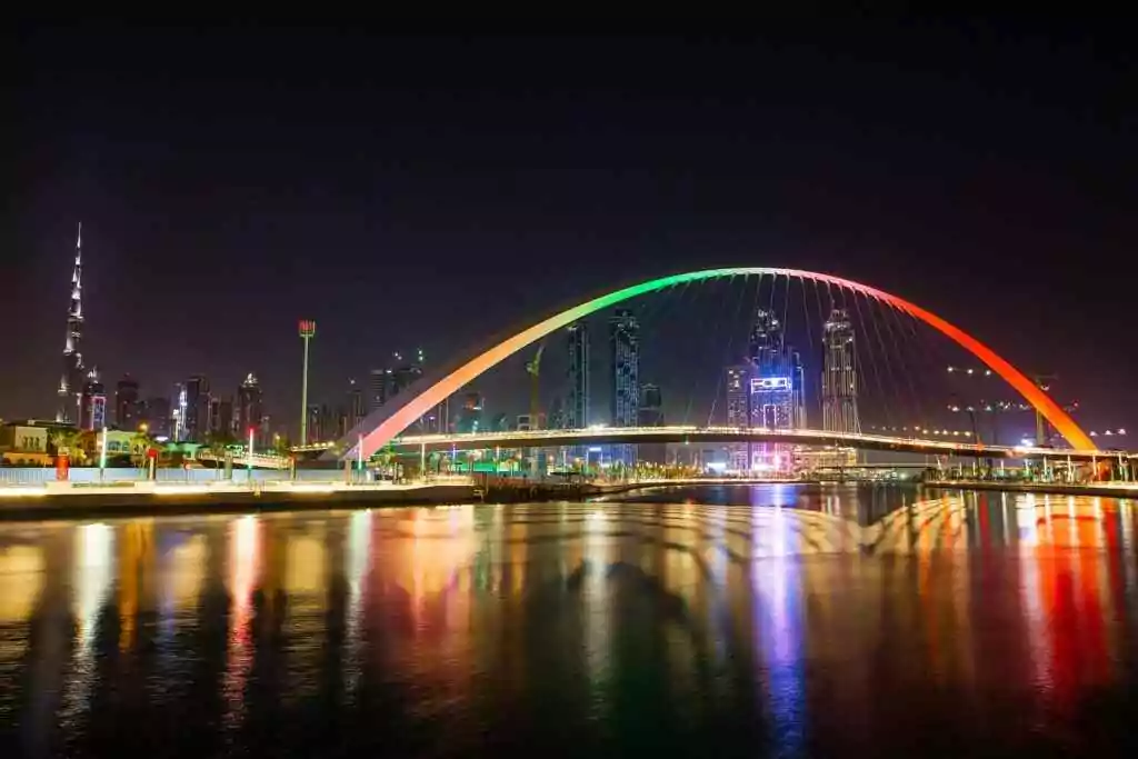 Dubai Creek FAST: Metro Hack in Minutes (Skip Taxis!) 5 Stunning view of Dubai's Tolerance Bridge and Burj Khalifa skyline illuminated at night.