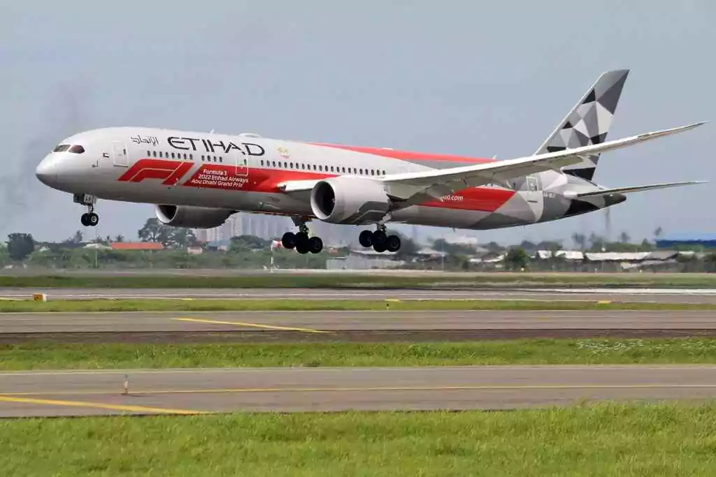 Ibn Battuta to Abu Dhabi Airport Bus — 2025 Update 16 Etihad Airways Boeing 787 Dreamliner landing on runway at an airport with Formula 1 livery.