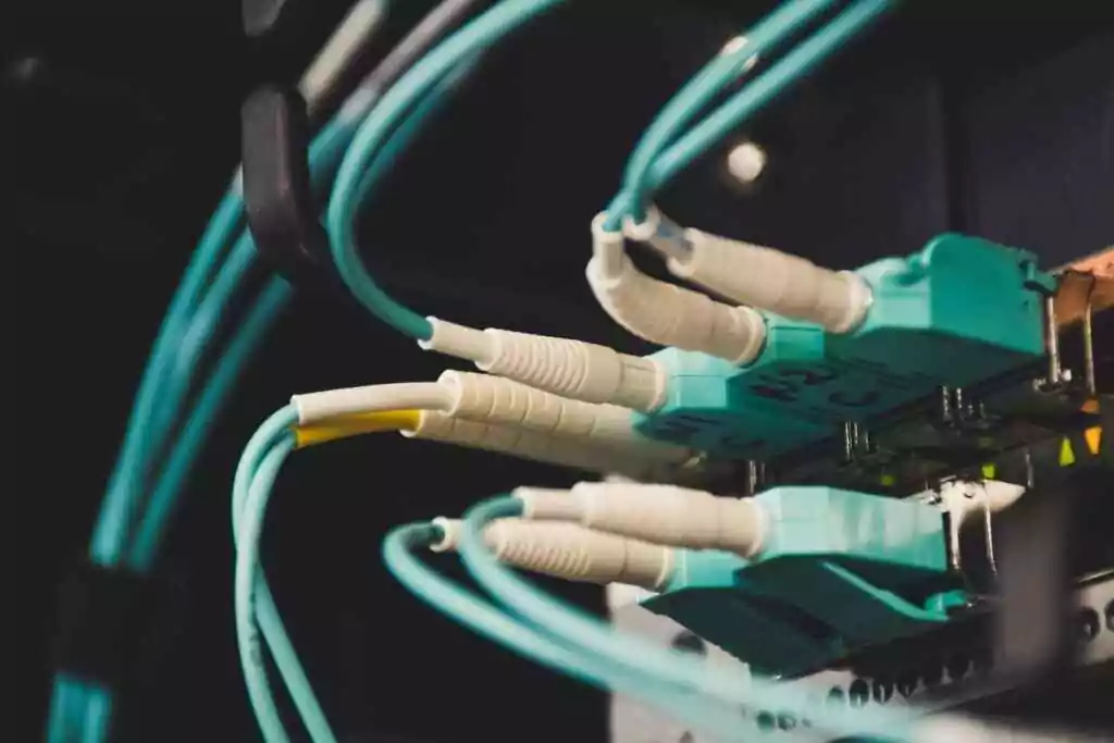 Bridging The Talent Gap: Training and Development Strategies In Cable Manufacturing 2 Detailed view of fiber optic cables and ports in a server room, showcasing connectivity.