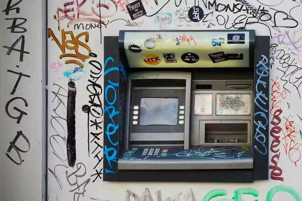 Never Overpay: 5 Free Ways to Check Lulu Salary (2025)! 20 An ATM embedded in a graffiti-covered wall, showcasing vibrant street art in a city setting.