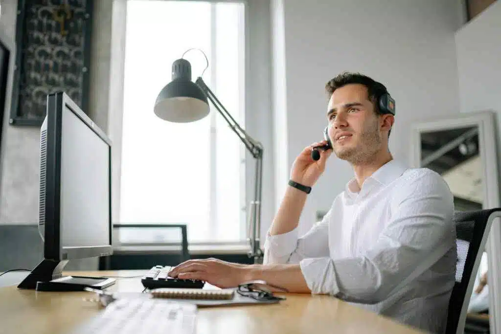 Never Overpay: 5 Free Ways to Check Lulu Salary (2025)! 19 Male call center agent with headset working at desk, providing excellent customer service.
