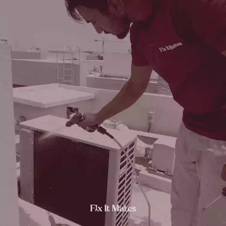 Transform Fixitmates Premier Home Maintenance and Joinery Services in Dubai 8 A man cleaning AC Outer