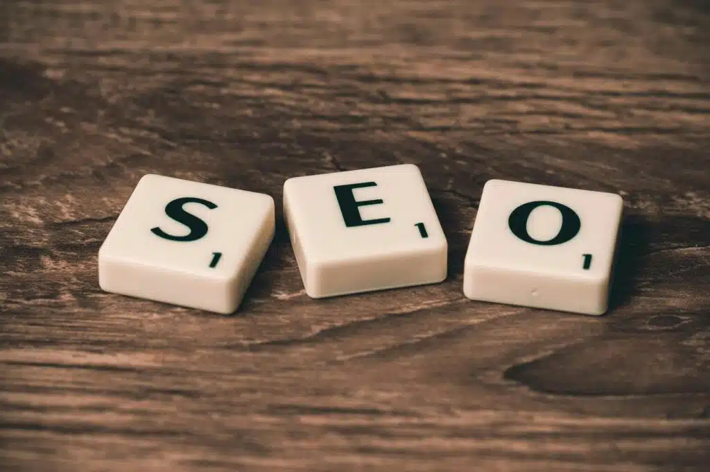 How to Increase Your Online Business in the UAE: SEO Strategies for 2025 and Beyond 2 Scrabble tiles spelling 'SEO' on a wooden surface. Ideal for digital marketing themes.