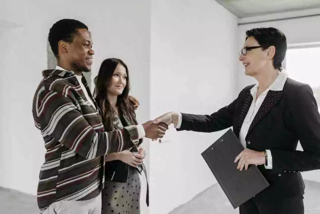 A woman shaking hand with other woman