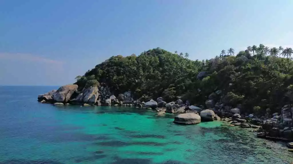 A breathtaking view of Ko Tao's lush coastline and clear turquoise waters, Thailand.