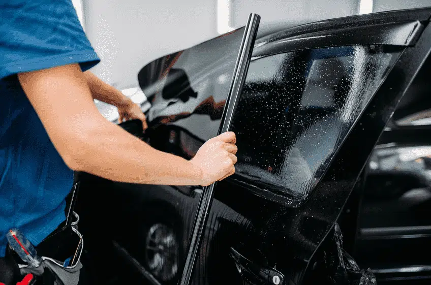 A man doing car winow tinting