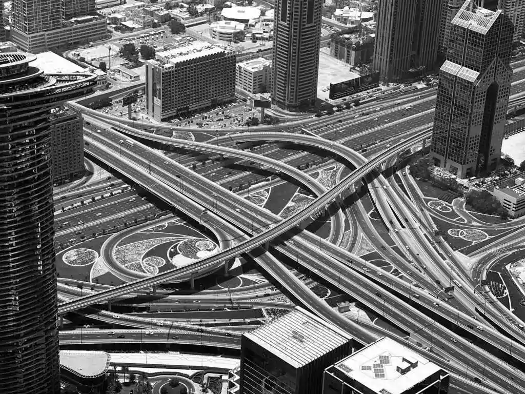 Explore the intricate road network and skyscrapers of downtown Dubai from above.
