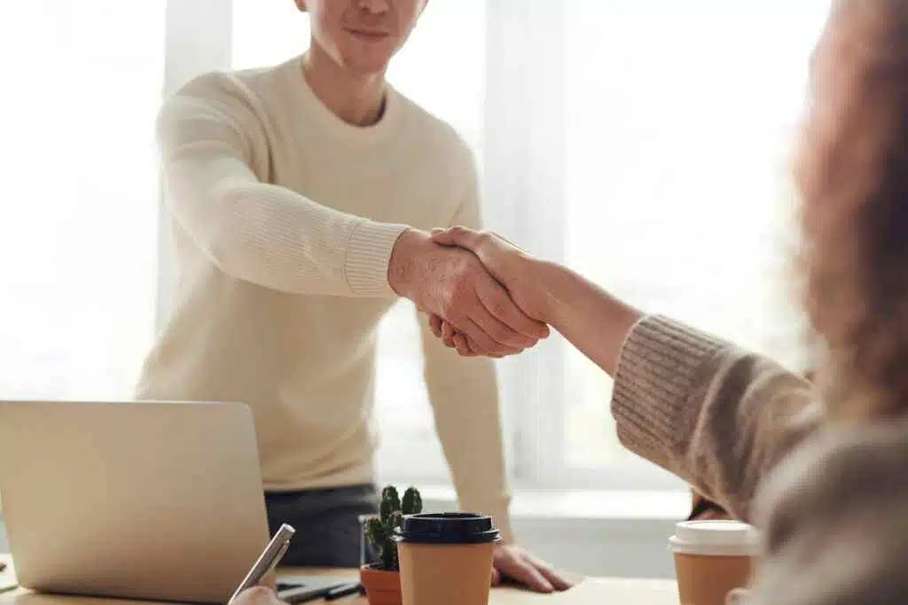 A man shaking hand with other man