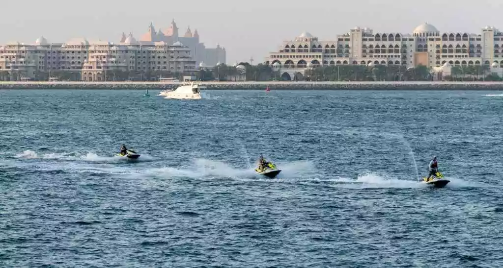 Exciting jet ski ride in Dubai with iconic skyline and sea backdrop, capturing urban adventure and water sports.