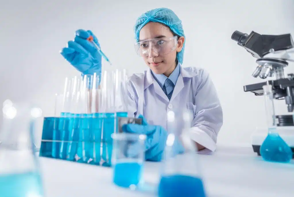 A female scientist using lab equipment for DPI TEST in a modern laboratory setting.