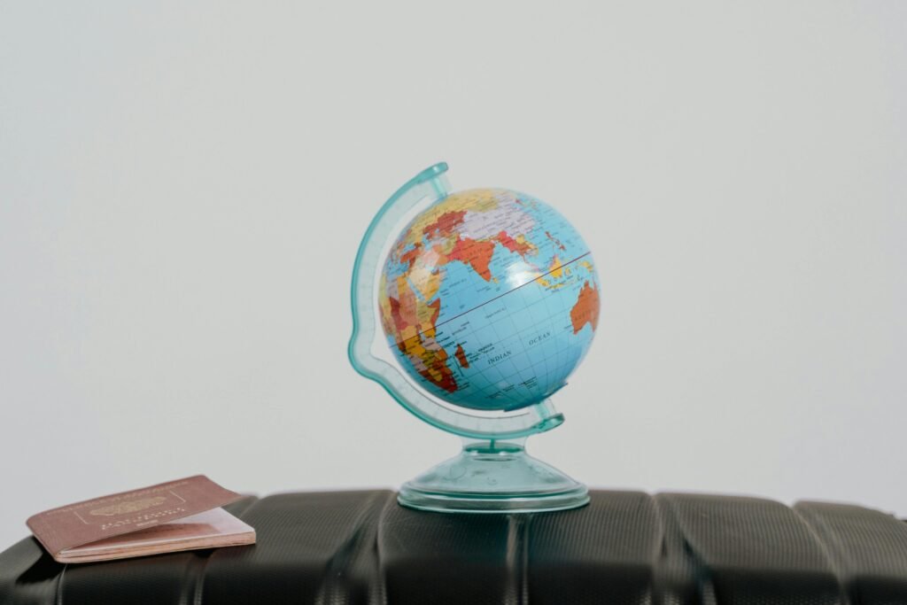 A globe and a passport on table