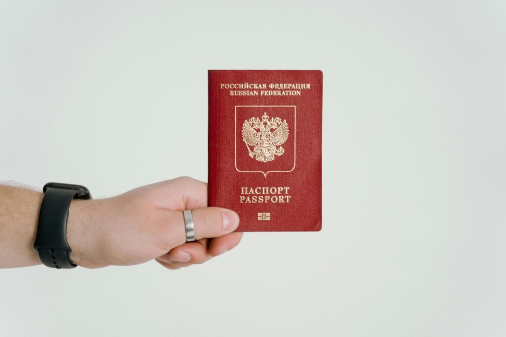 A red passport in hand