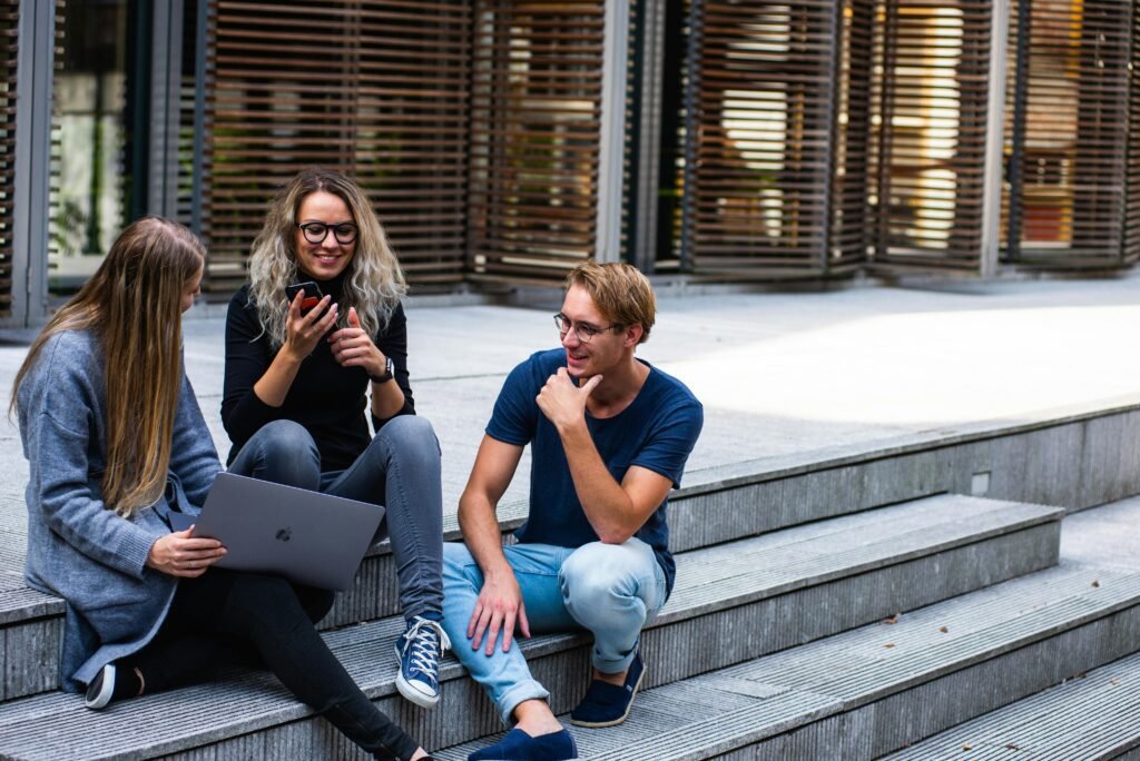 Two girls and a boy talking