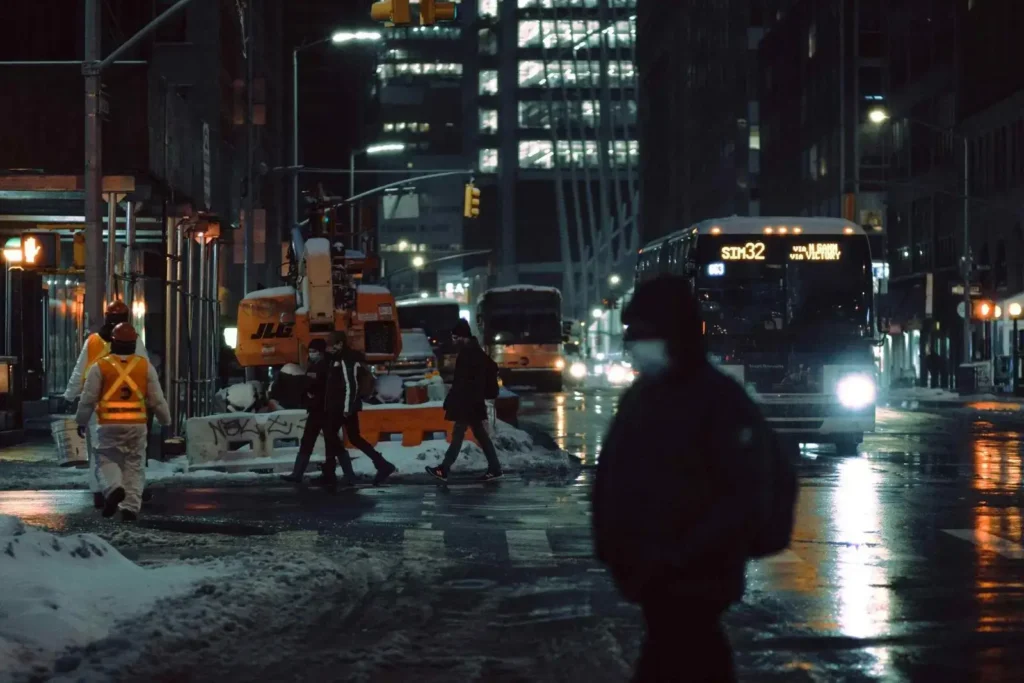 A night view of a busy road with a bus on it