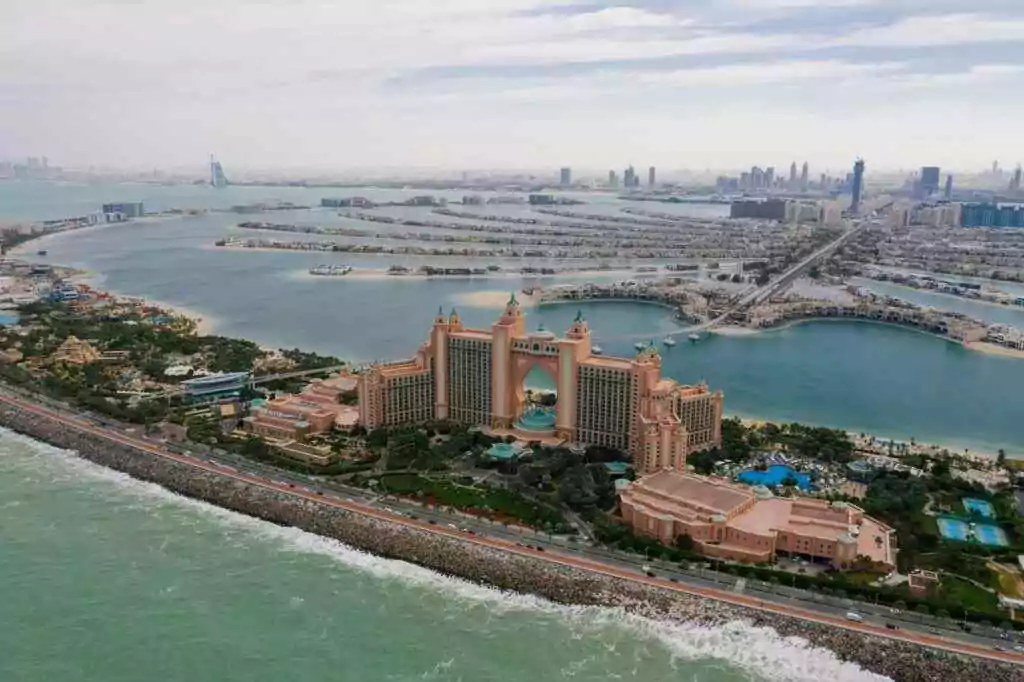 A stunning aerial view of Atlantis The Palm hotel with Dubai's skyline and sea in the background.