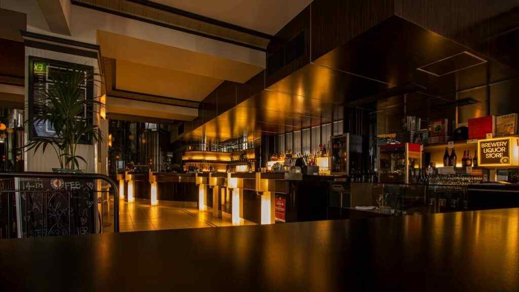 Where to Eat Cheap in Abu Dhabi? 5 Best Affordable Spots! 9 Stylish modern restaurant interior with warm lighting, elegant design, and luxurious ambiance at night.