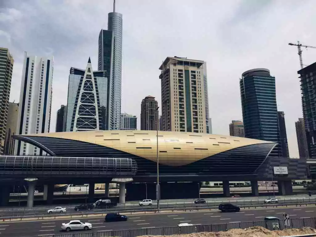 Dubai's futuristic metro station with iconic skyscrapers in the background showcase modern architecture.