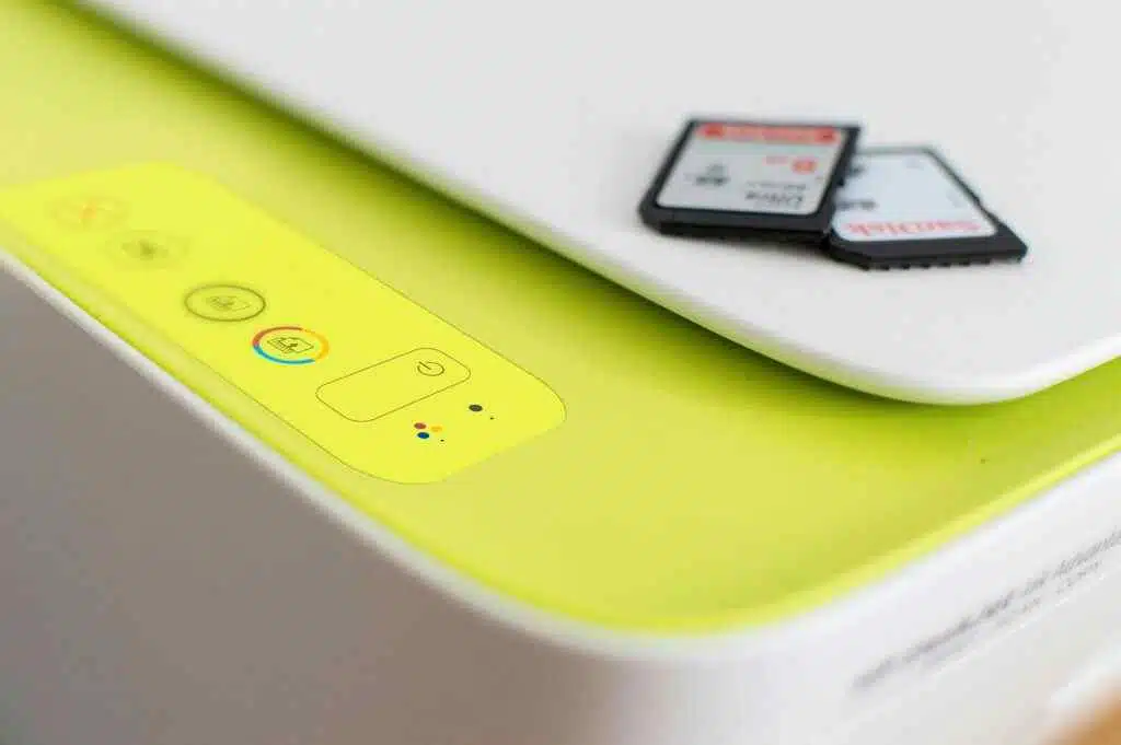 Detailed shot of a printer's control panel with SD cards on top, highlighting modern tech.