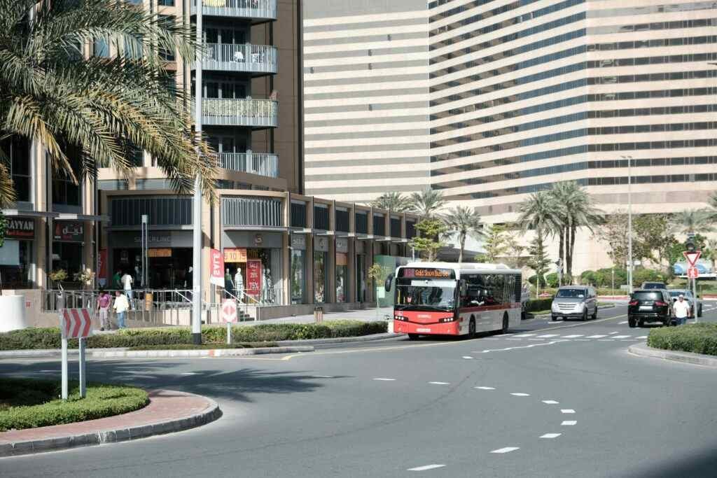 Urban view of Dubai showing modern architecture and city life with a bus on the street.