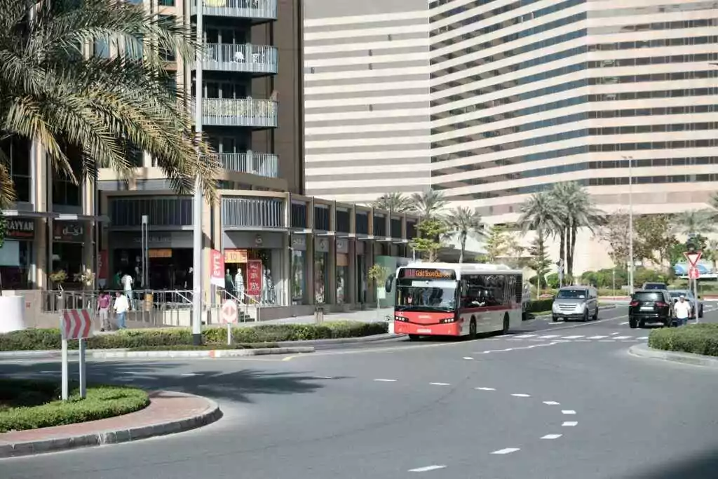 Urban view of Dubai showing modern architecture and city life with a bus on the street.