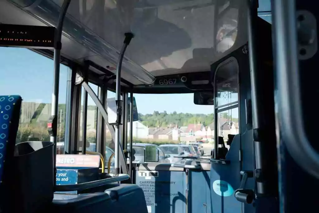 Interior of a public bus with view of town and blue sky outside.