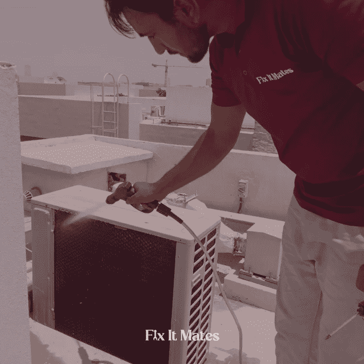 A man cleaning AC Outer