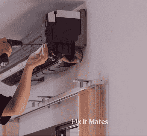 A man cleaning AC
