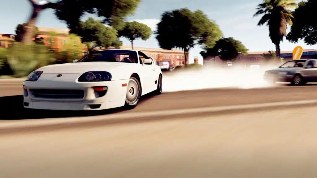 A white sports car drifting on a sunny day with smoke trail on an urban road.