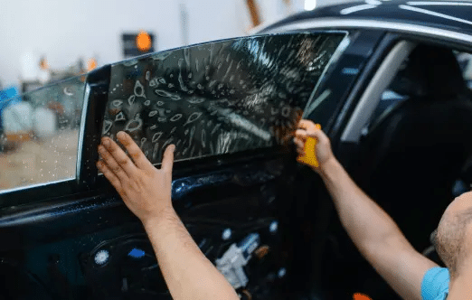 A man doing car tinting.