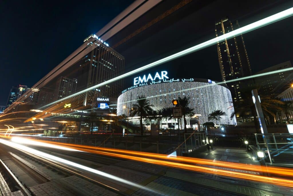 Key Features of the UAE PPP Calculator Night view of Dubai Marina Mall with dynamic light trails creating a vibrant urban scene.