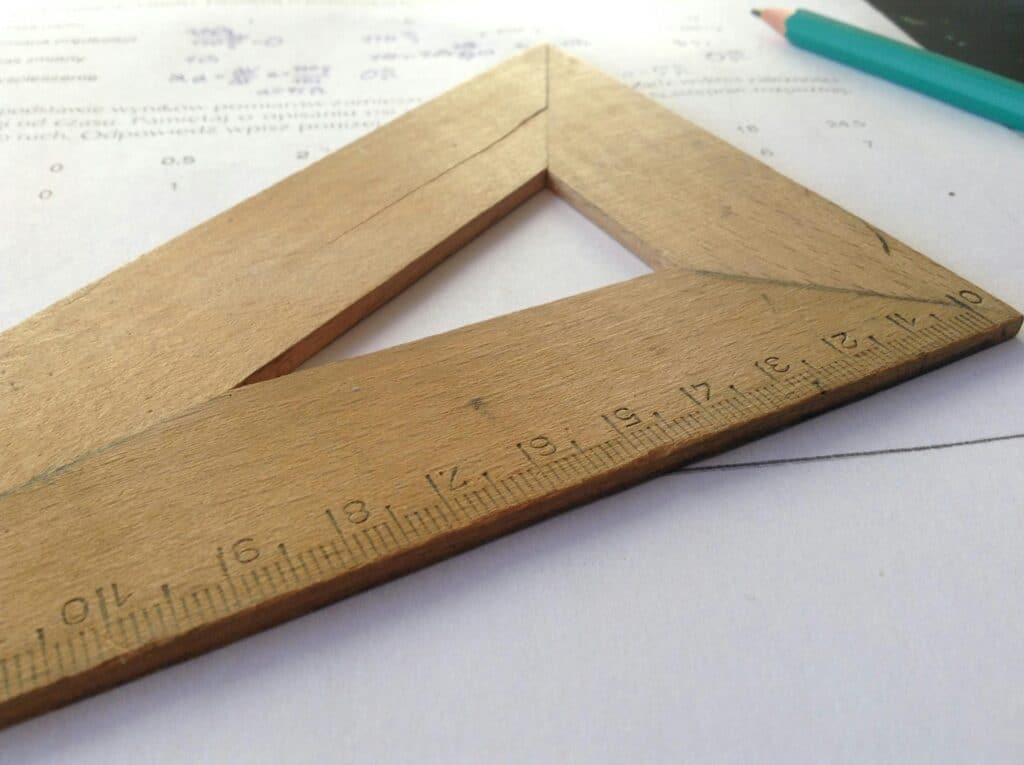 Close-up of a wooden ruler on paper, ideal for educational themes and measuring concepts.