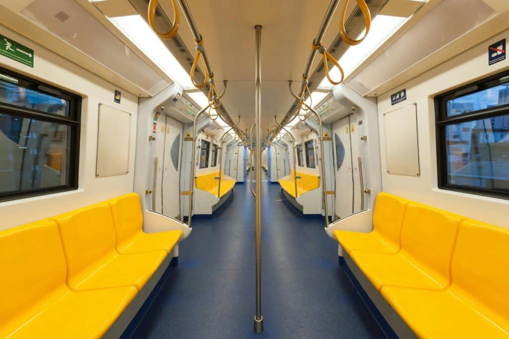 Dubai Metro Fare 2026 Guide: Zones, Costs & Nol Cards 3 Interior of a modern subway car with bright yellow seats and clean design, emphasizing public transportation.